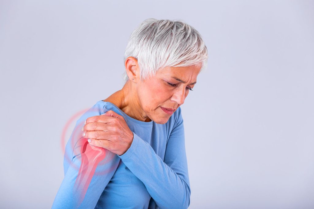 Woman experiencing shoulder pain with joint highlighted in red