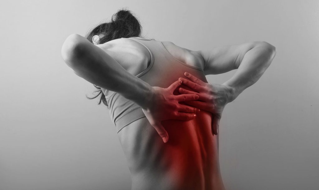 Woman clutching upper back with visible red pain highlight area